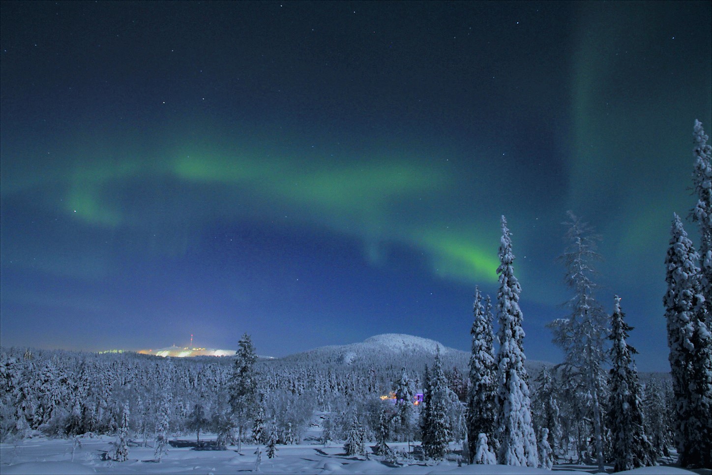The land of Northern lights, evening snowmobiling in the taiga forest